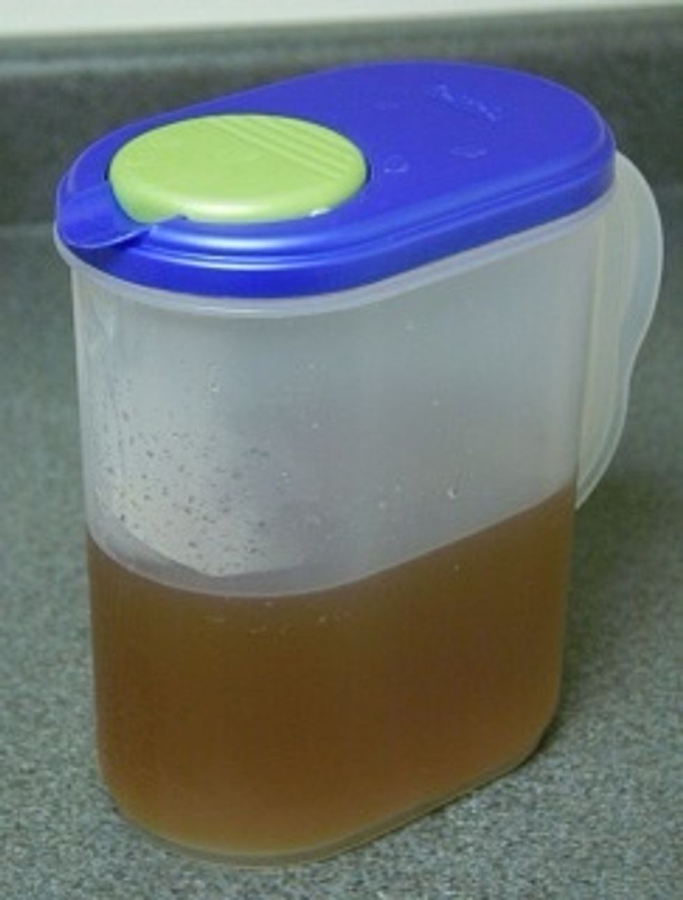 Pour tea into a pitcher and add ice cubes until the volume has returned to two quarts.