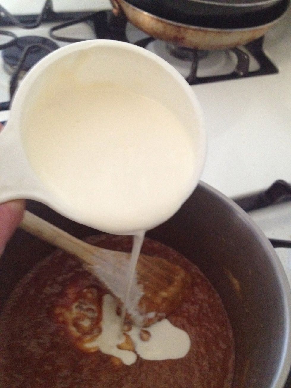 Pour the 1/2 cup of cream slowly into the caramel.