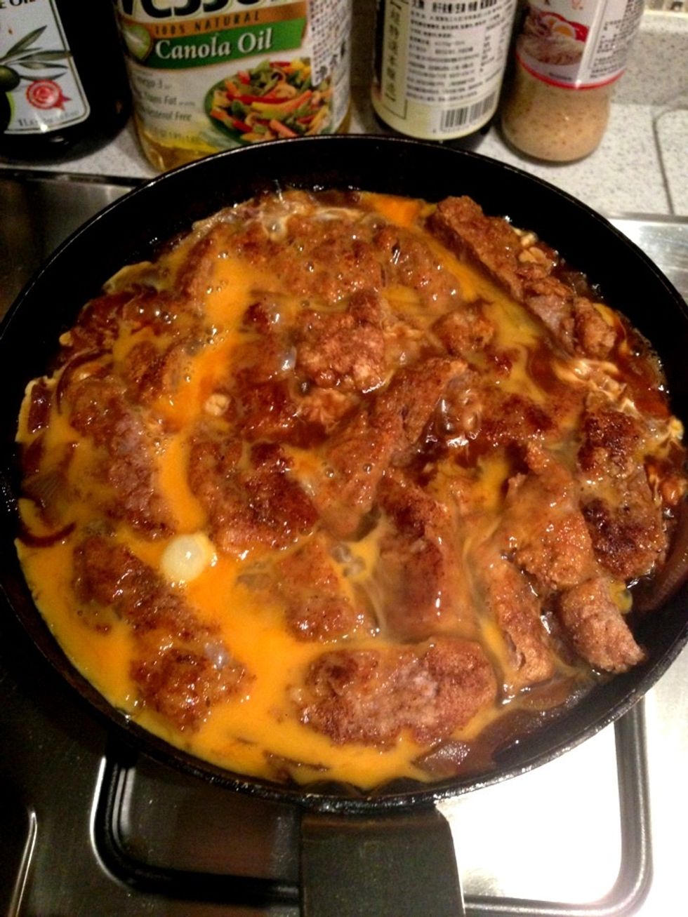 Pour the 2 beaten eggs into the pan and allow to heat for approx 1 min or until eggs are half cooked. It should be slightly watery. Turn off the heat & cover with lid allowing everything to soaked in.