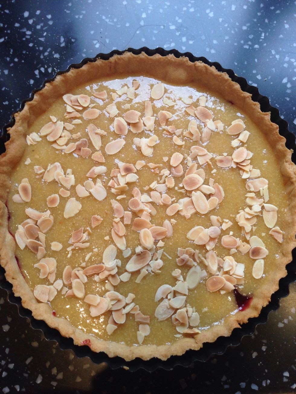 Pour the almond mix into the pastry and cover the jam. Sprinkle flaked almonds over the top