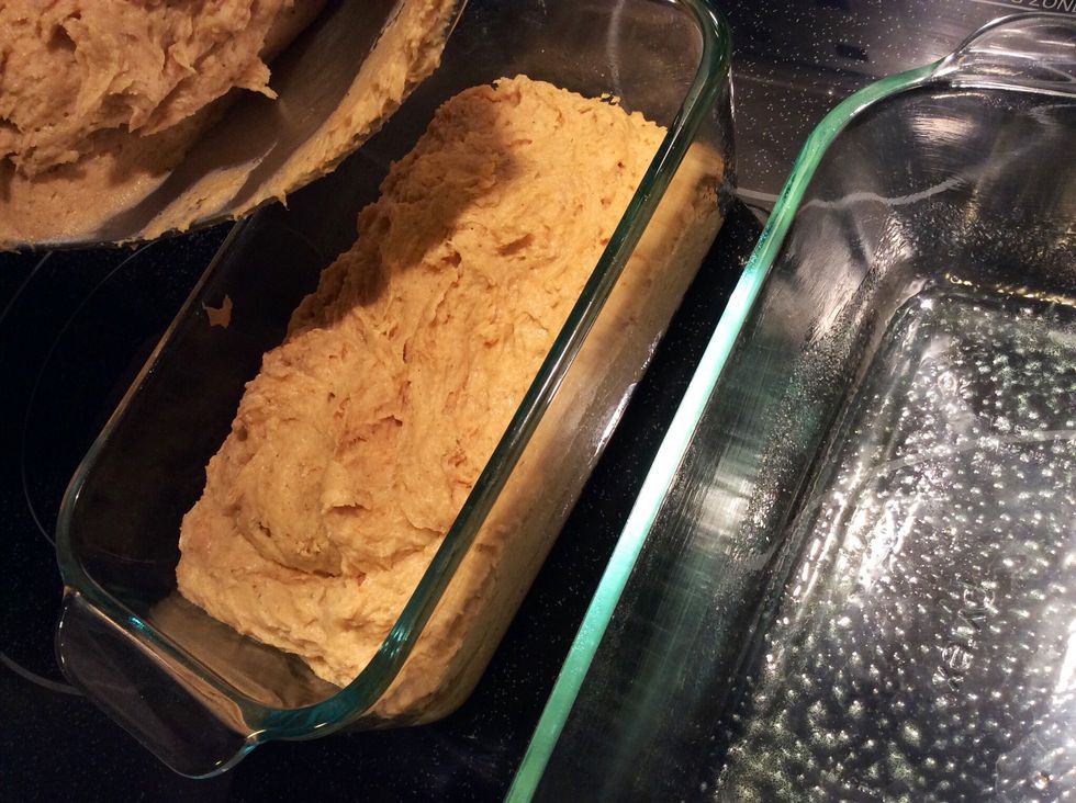 Pour the batter evenly into the two butter sprayed bread pans.