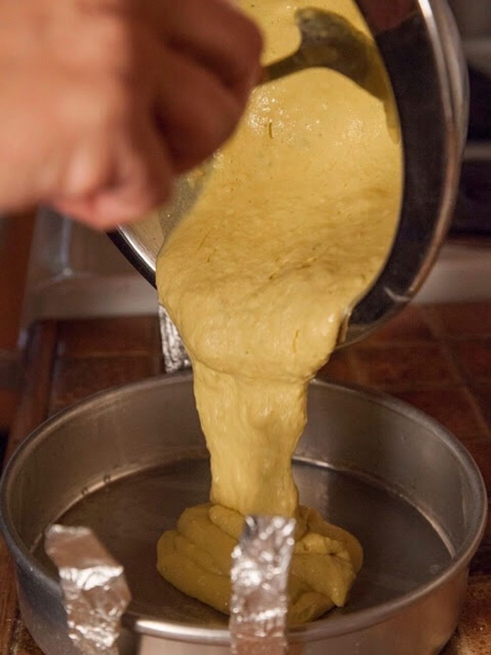 Pour the batter into the greased pan.