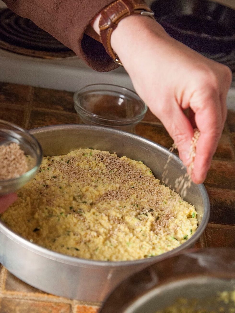 Pour the batter into your pan. Scatter 2 Tbs of sesame seeds over the top.