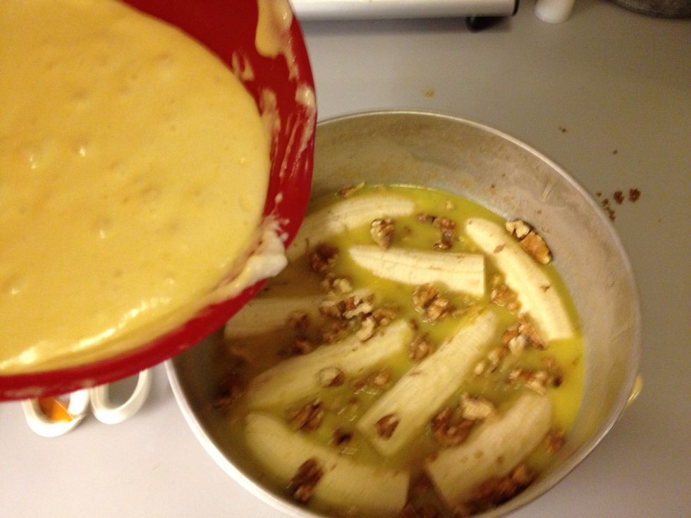 Pour the batter over the bananas and walnuts.