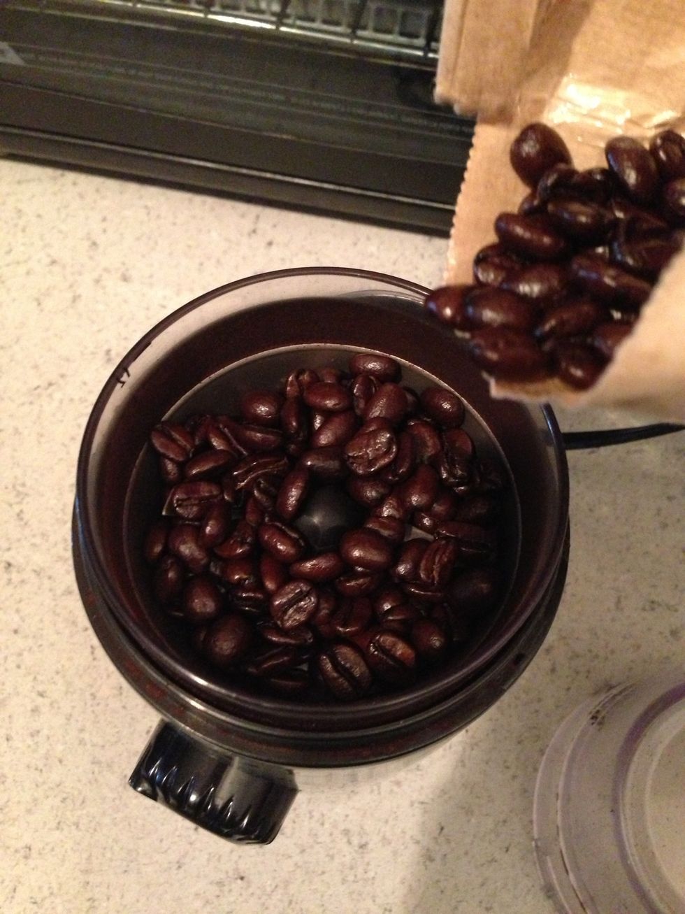 Pour the beans into your grinder
