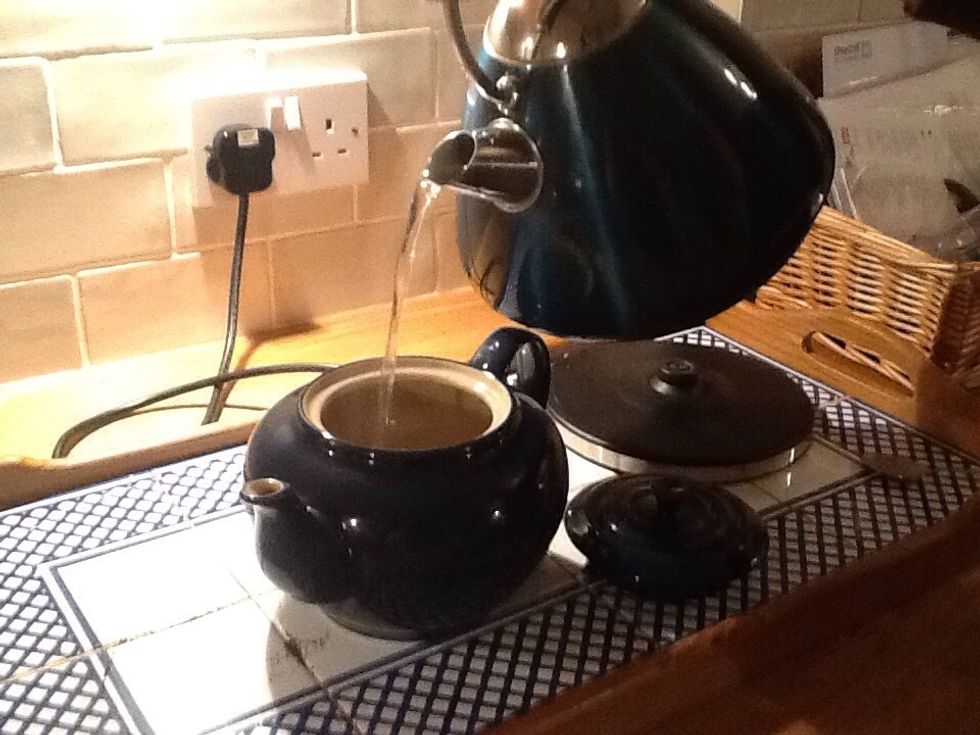 Pour the boiling water into the tea pot.