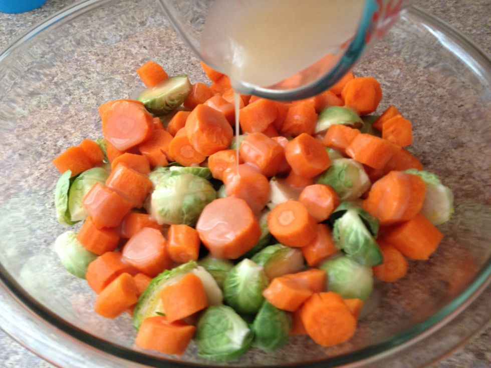 Pour the butter/ syrup mixture over the Brussels sprouts and carrots. Add salt and pepper. And stir with a spoon to evenly coat the vegetables.