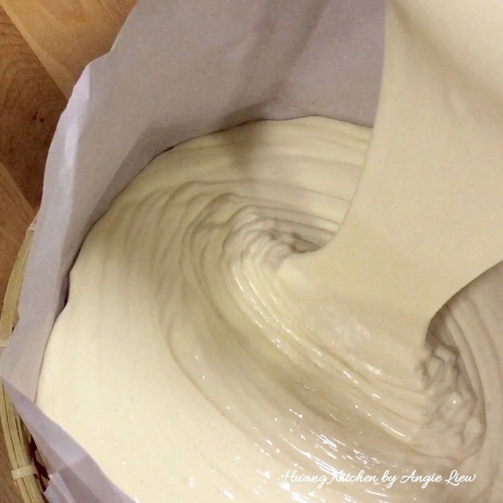 Pour the cake batter into the prepared lined bamboo steam tray.