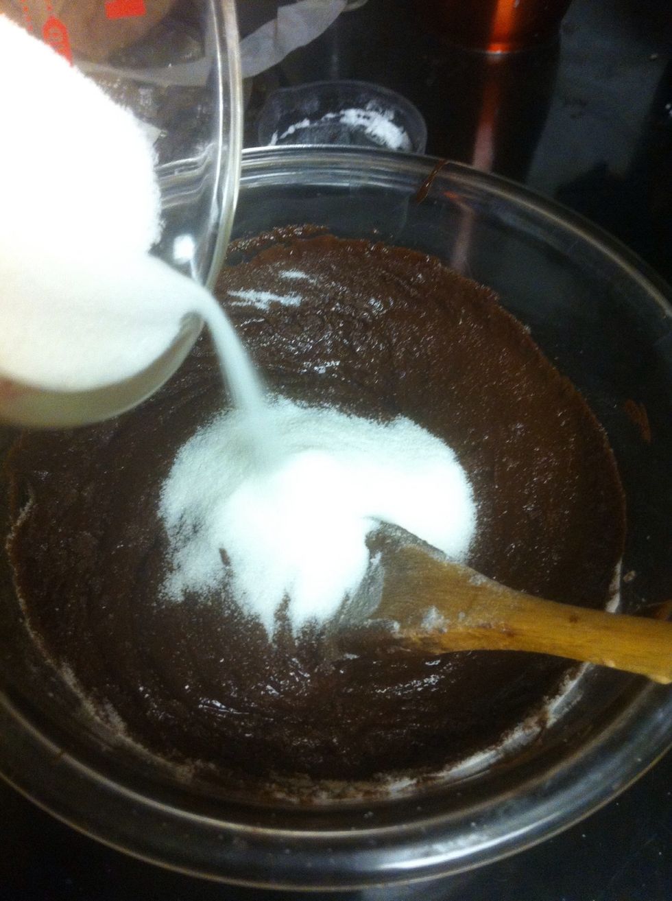 Pour the chocolate mixture into a medium bowl, and gradually add in the sugar.
