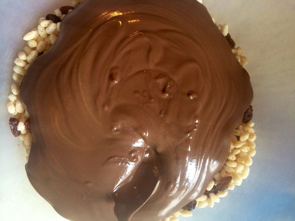 Pour the chocolate over the rice crispies and sultanas.