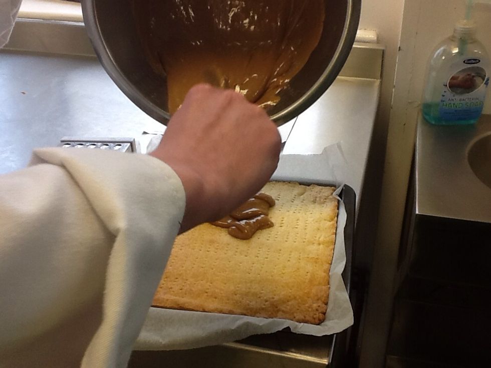 Pour the condensed milk into a bowl and stir it up, then pour on to the shortbread