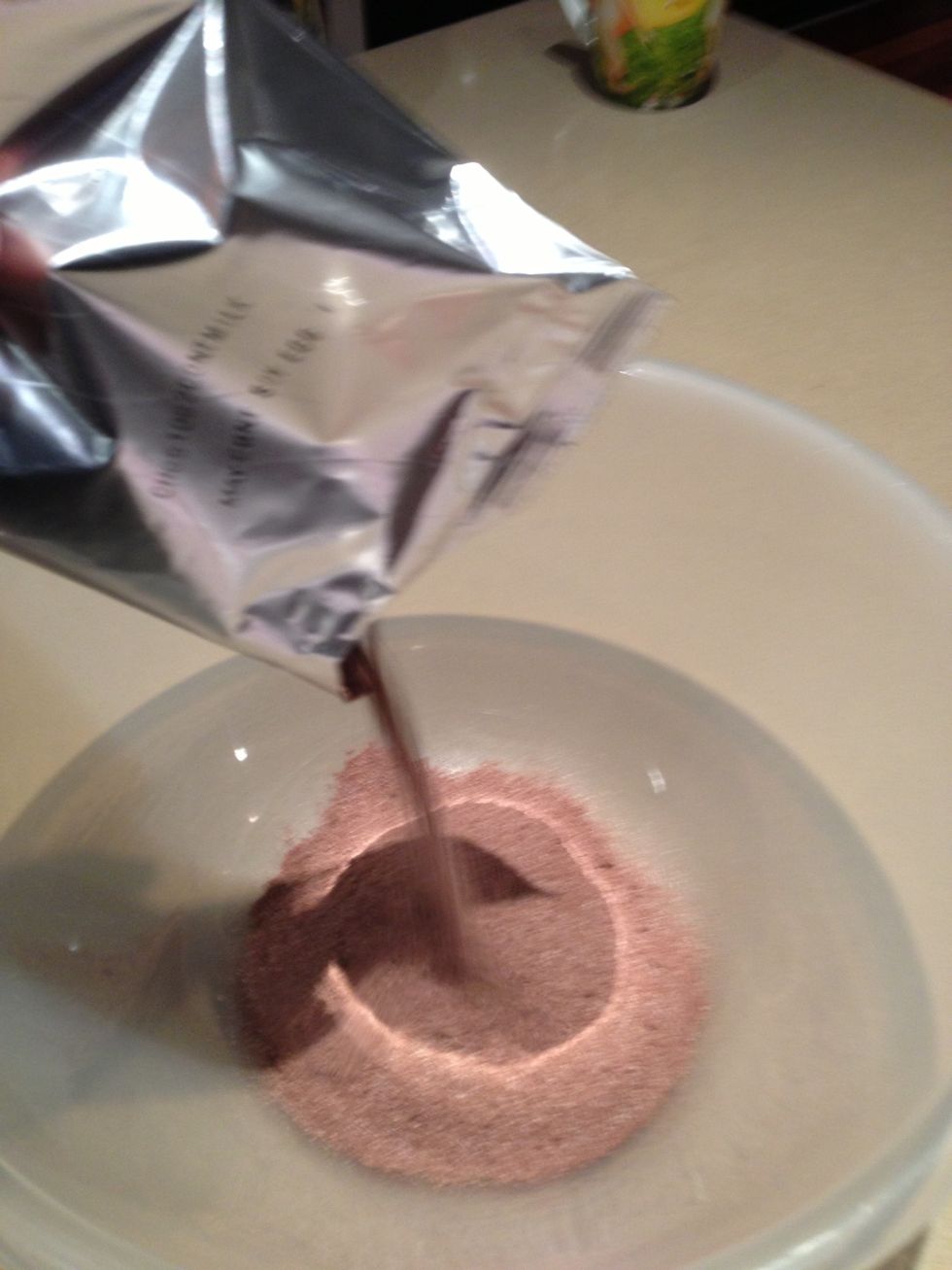 Pour the contents from the packet into a large mixing bowl. If you want to make it from scratch add 1/2 cup of caster sugar, 1/2 cup of cocoa powder and 4 egg yolks