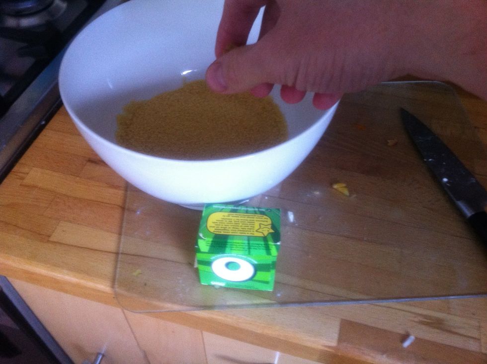 Pour the couscous into a bowl and crumble a veg stock cube.