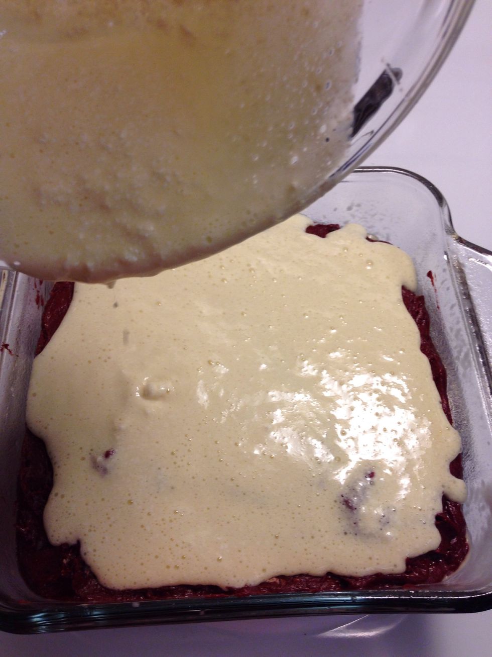 Pour the cream cheese batter on the brownie mix