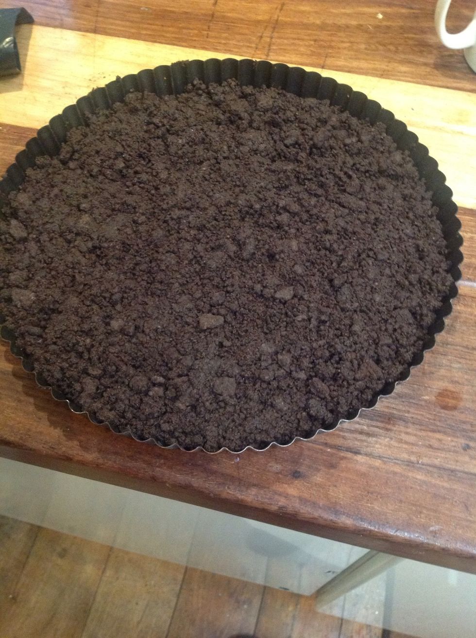 Pour the crumbs into cake tin. Press firmly so that the crust evenly lines the bottom of the cake tin.