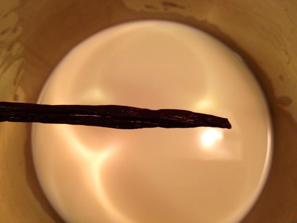 Pour the fat milk and the cream in a pot. Add an opened vanilla pod to it as well.