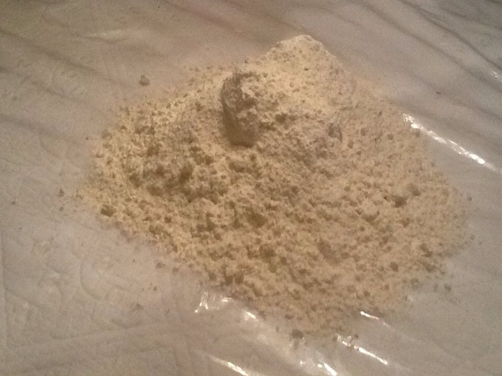 Pour the flour on the table like this and take the butter on it. Mix it with your hands.