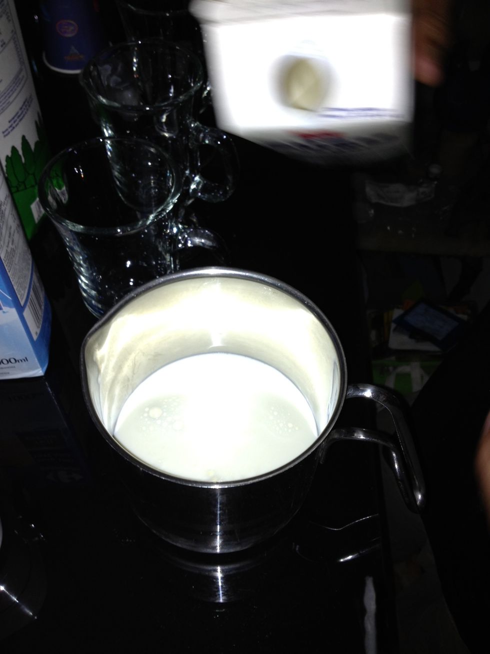pour the fresh milk in a stainless steel glass