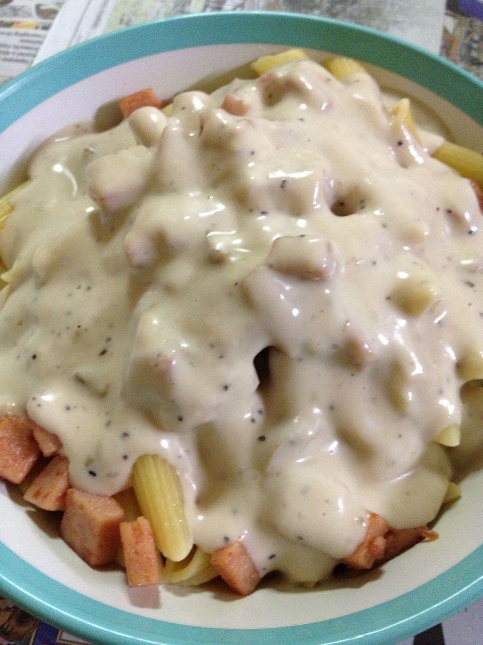 Pour the heated carbonara sauce onto the pasta.