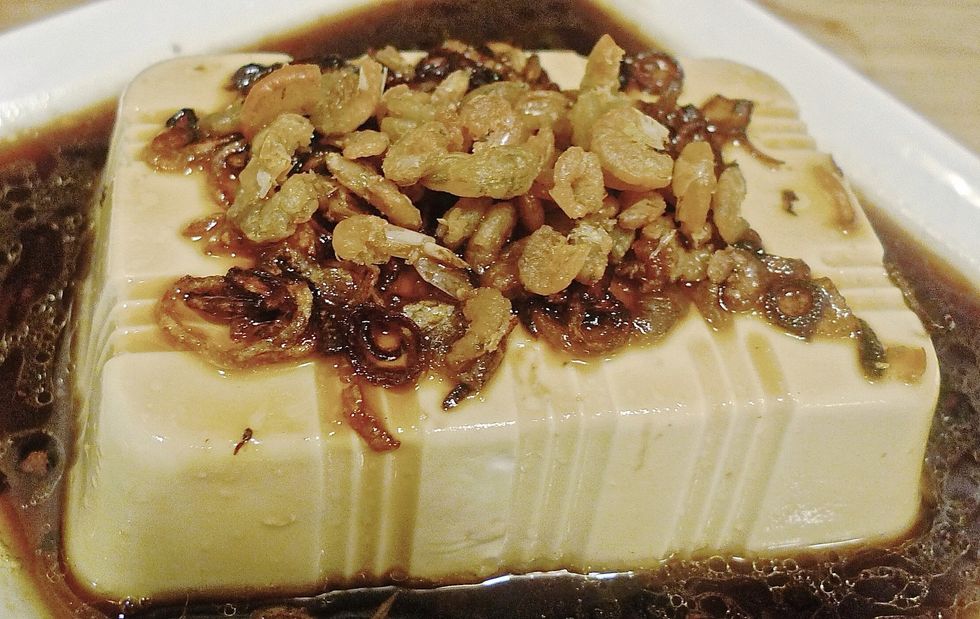 Pour the hot seasoning mixture over the bean curd. Then top with fried dried shrimps.