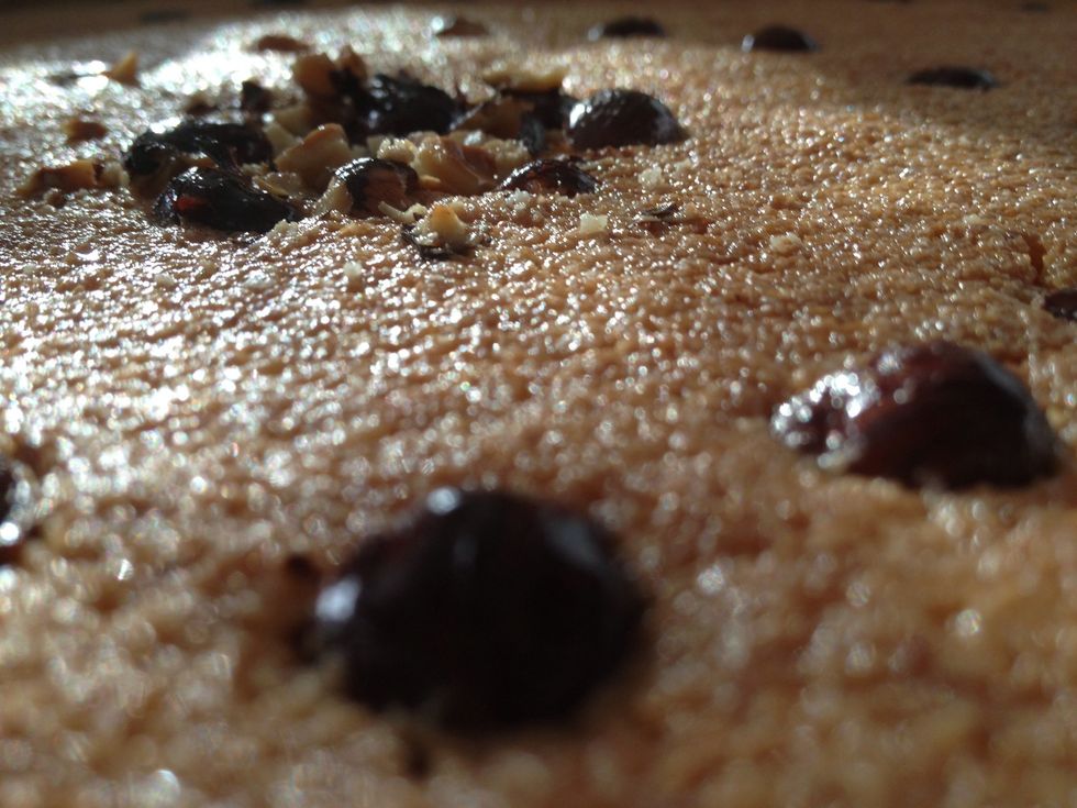 Pour the hot syrup mixture into the surface of the basbousa while its still warm. Don't worry,  it will seep in. Place your basbousa into your oven (it's off, but should still be warm) for 10 minutes.