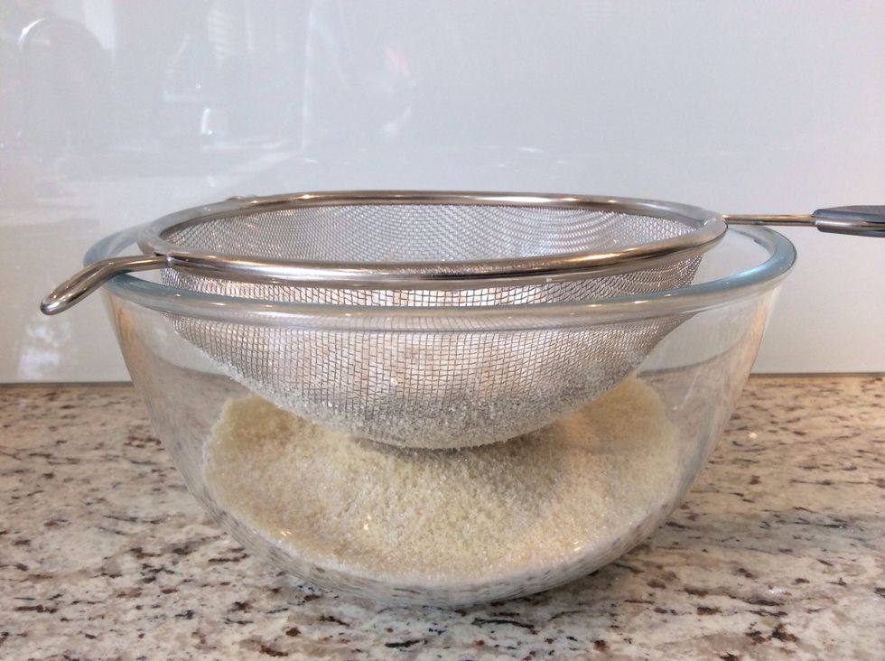 Pour the icing sugar into the sieve and sift to remove any bumps and lumps (2-3 minutes)