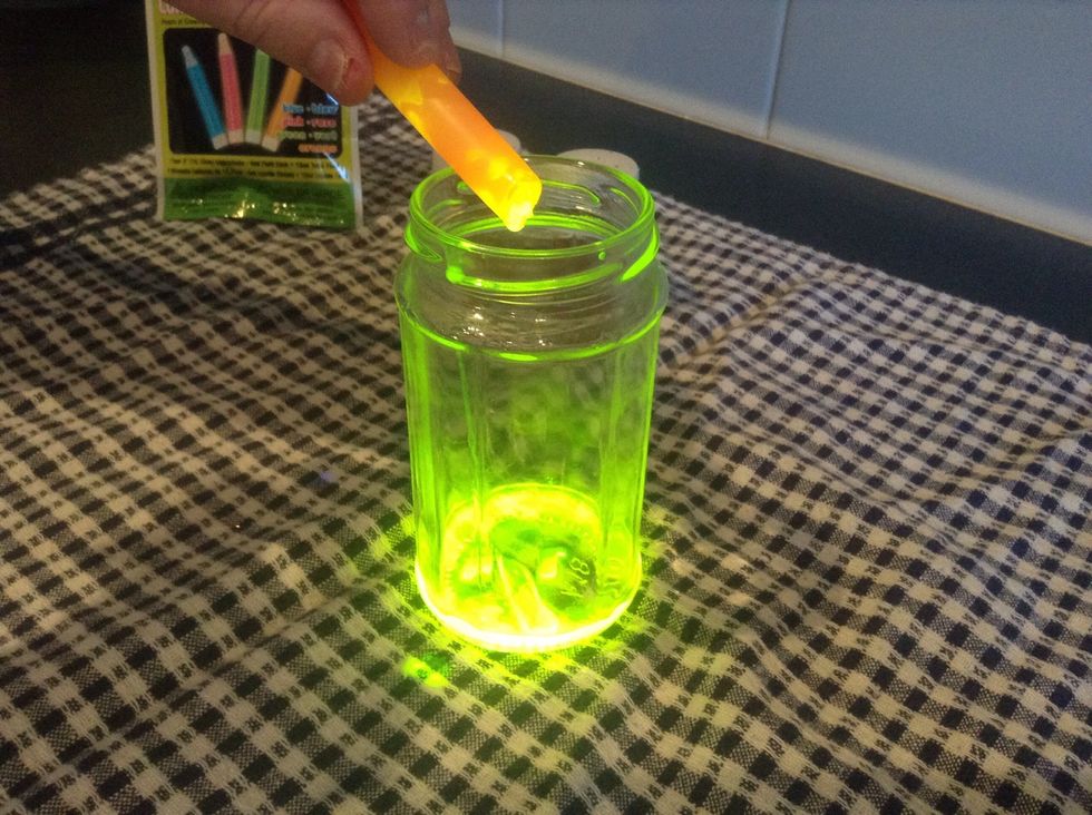 Pour the liquid from the glow stick into the jar.