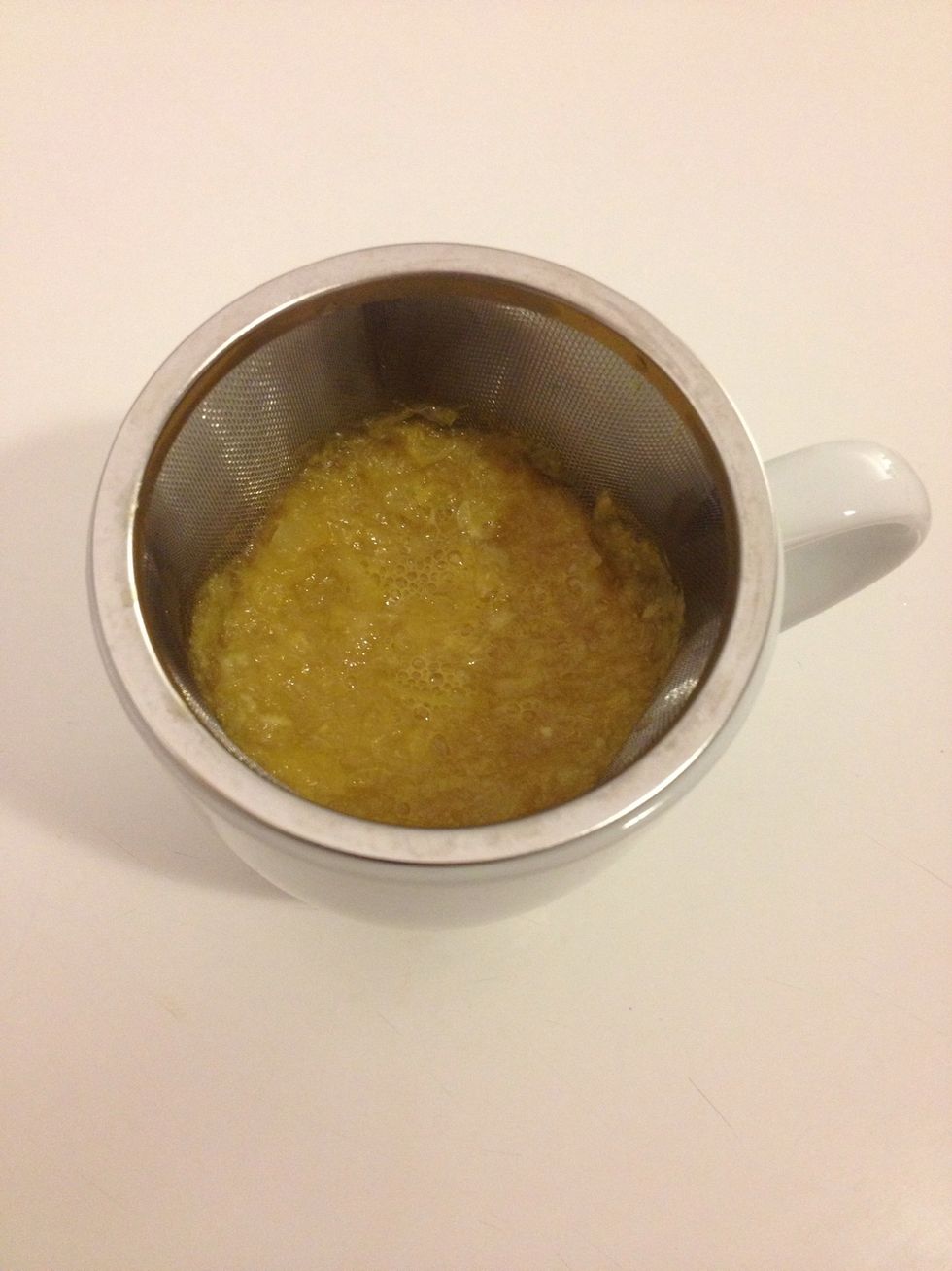 Pour the liquid through the strainer. I usually grab a spoon to press more juice out of the pulp.