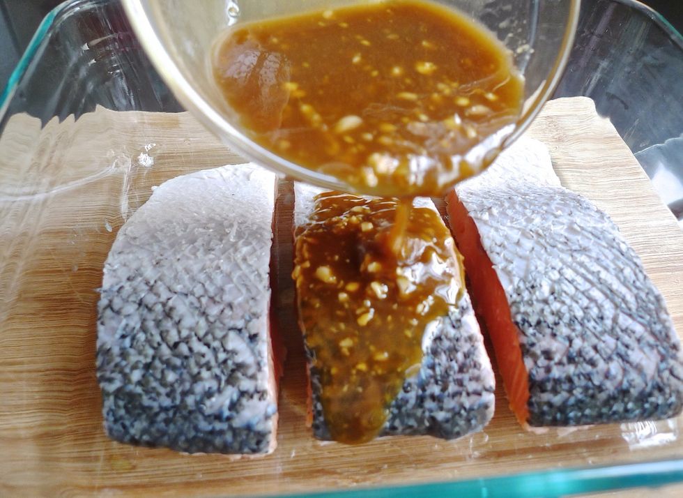 Pour the marinade over the salmon fillets.