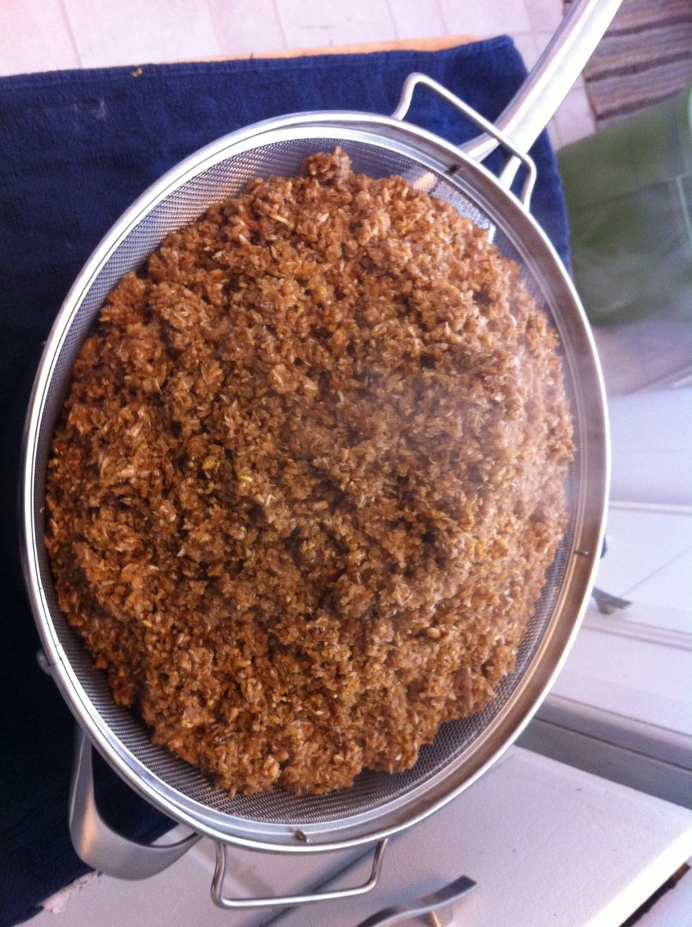 Pour the mash over a strainer into a second pot. This is called sparging. Pour the gallon of water that is at 170degrees over the sparge and repeat three times. This is extracting the sugars.