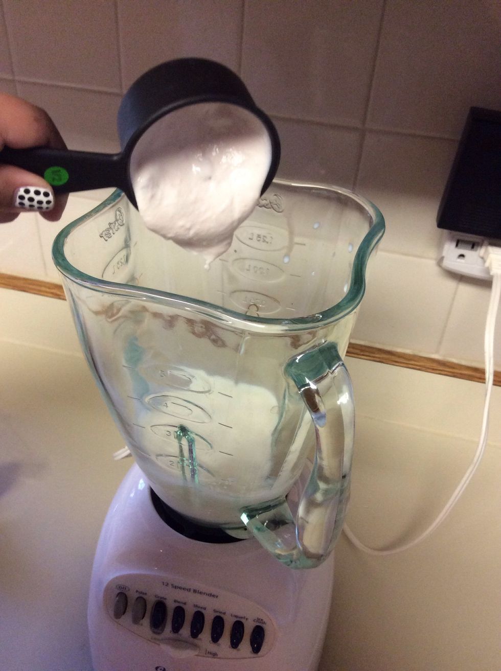 Pour the measured yogurt into the blender.