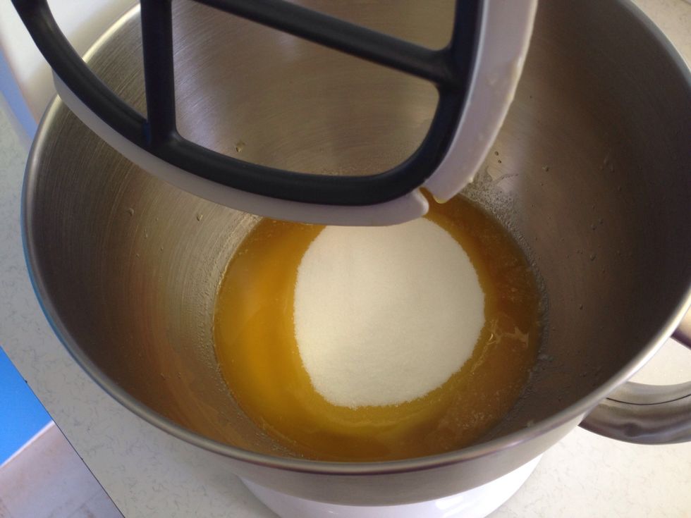 Pour the melted butter into the mixer and add the caster sugar and vanilla extract.
