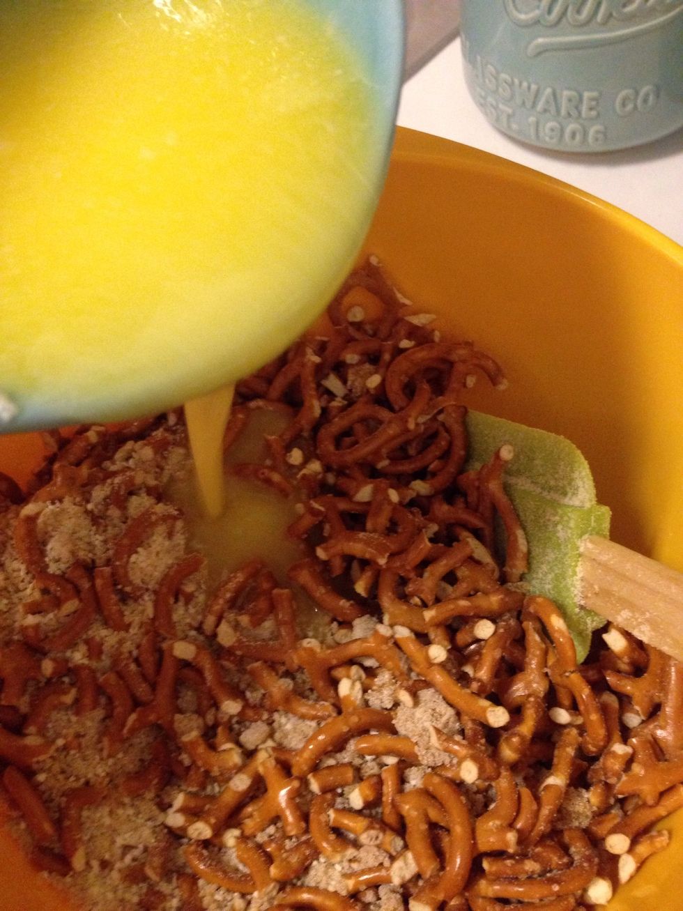 Pour the melted butter over the pretzel mixture and stir until ALL of the pretzels are coated