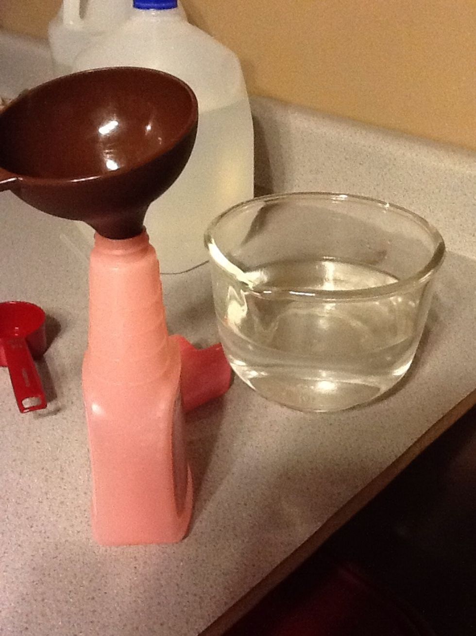Pour the mixture into a spray bottle. I used an empty bottle I had but it was small so I ended up using 2 bottles. A funnel helps so you don't spill it all over.