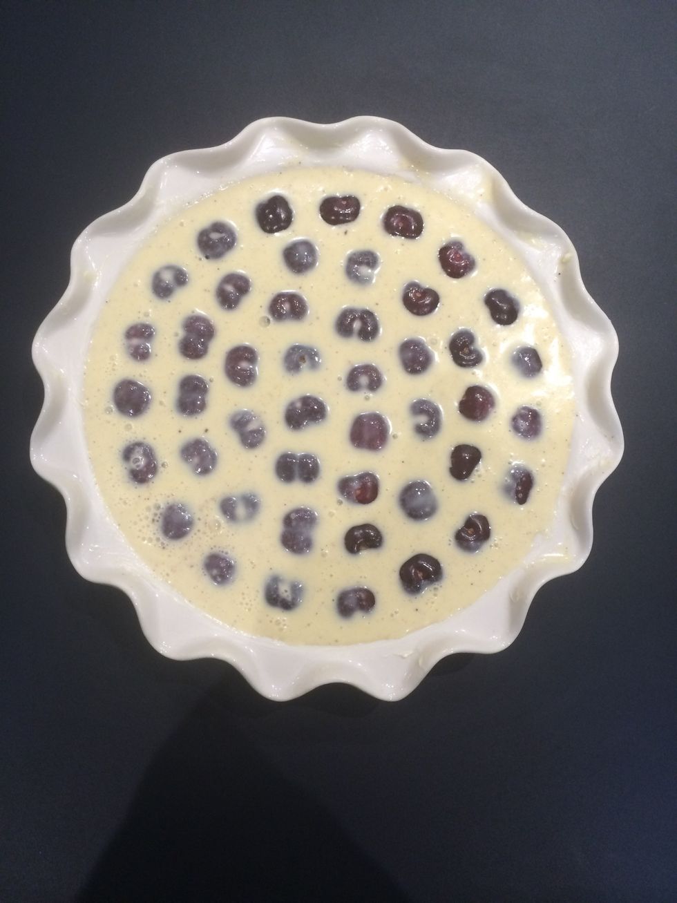 Pour the mixture over the cherries and bake in a preheated oven 200C for 40 mins.. Until golden and set.