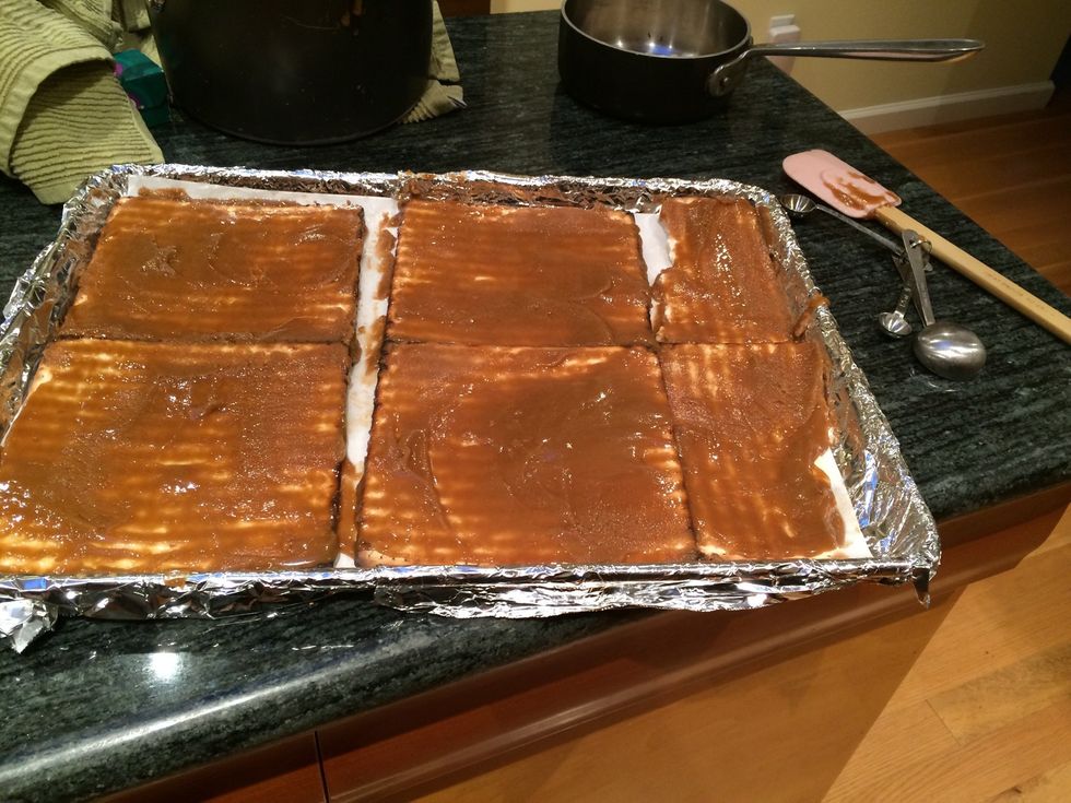 Pour the mixture over the matzohs and spread evenly.