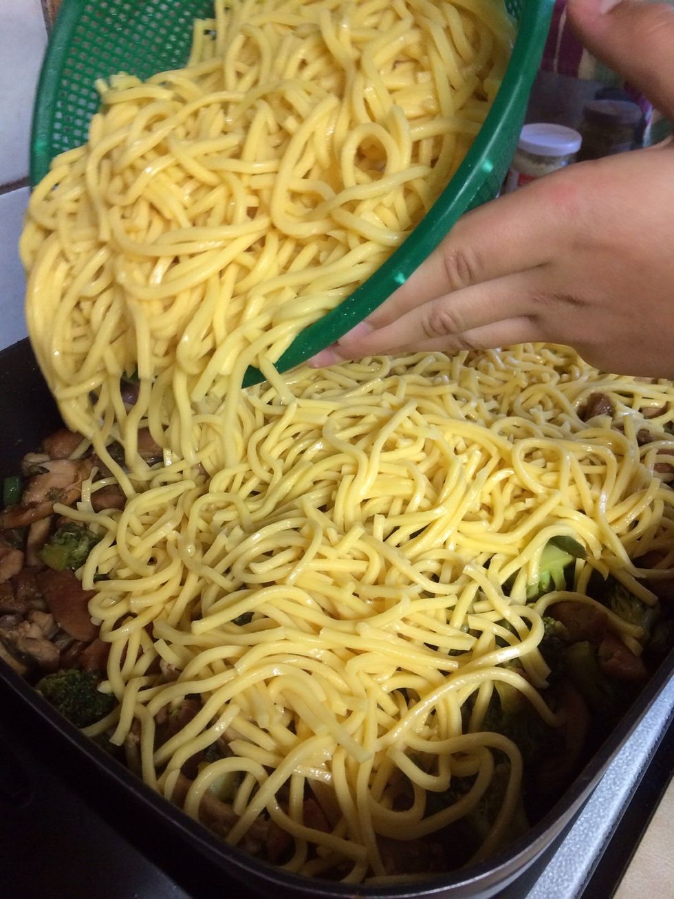 Pour the noodles into the pan and stir in with the chicken and vegetables.