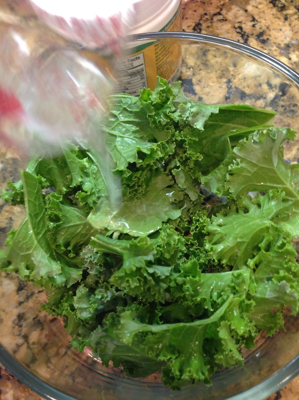 Pour the oil over the torn kale.
