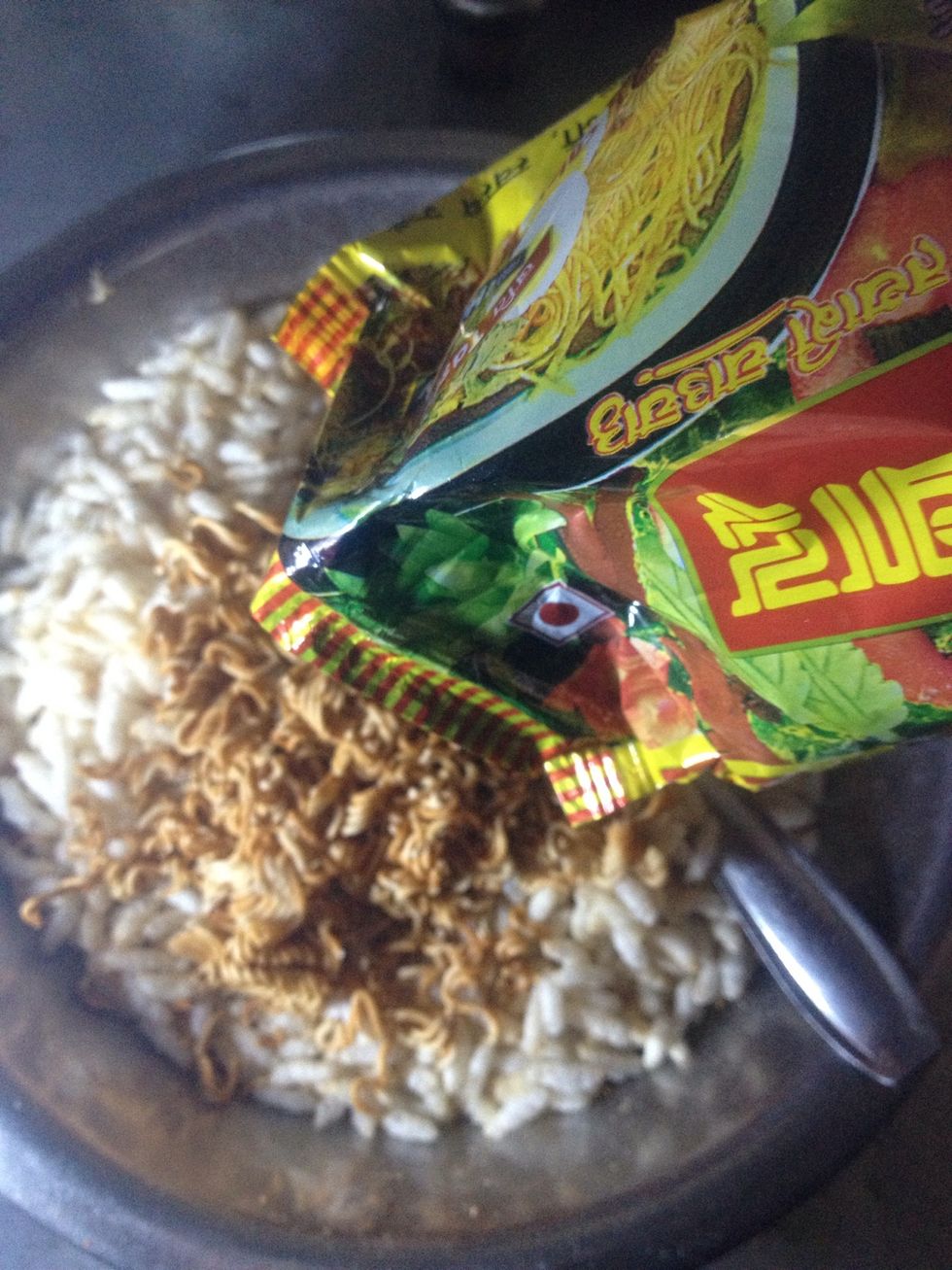 Pour the pack of Nepali Noodle in a bowl with puffed rice.