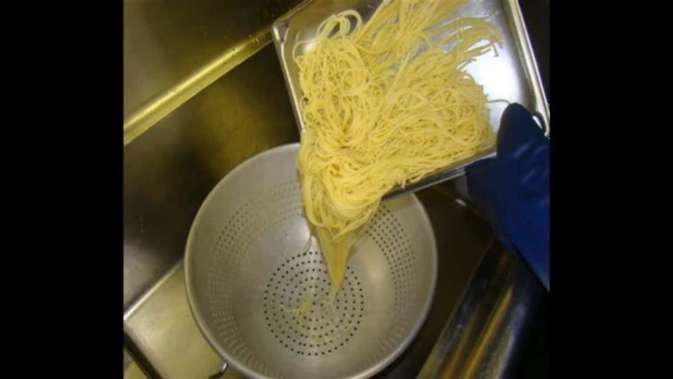 Pour the pasta into a colander.