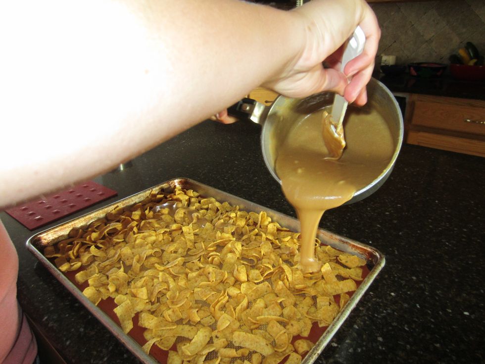 Pour the peanut butter over the Fritos.