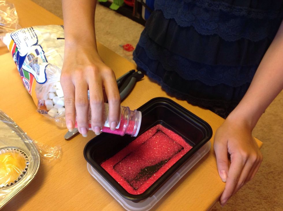 Pour the pink sprinkles into a container. Make sure it has a cover that can close the container.