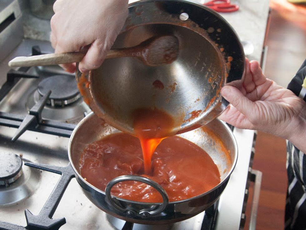 Pour the reduced sauce back into the skillet or kadhai.