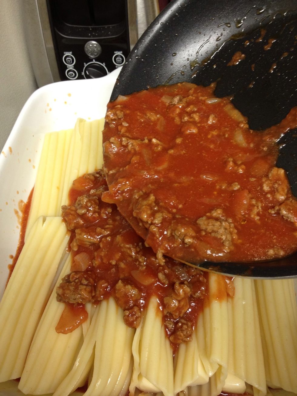 Pour the remaining sauce mixture on top of the stuffed noodles.