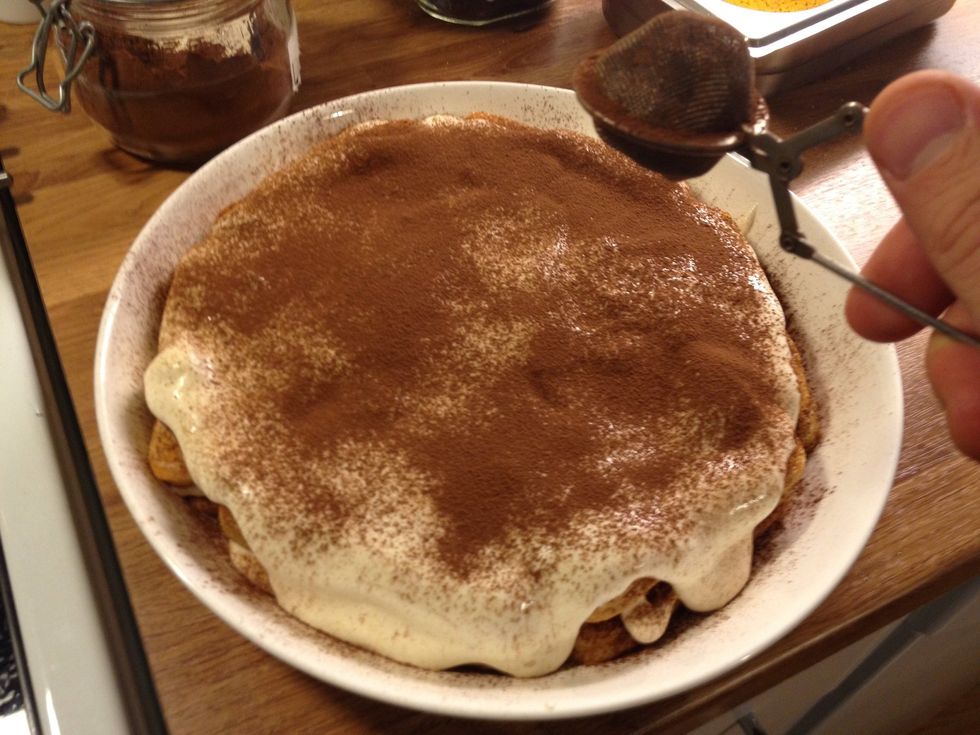 Pour the rest of the egg mixture on top and sieve cocoa powder.