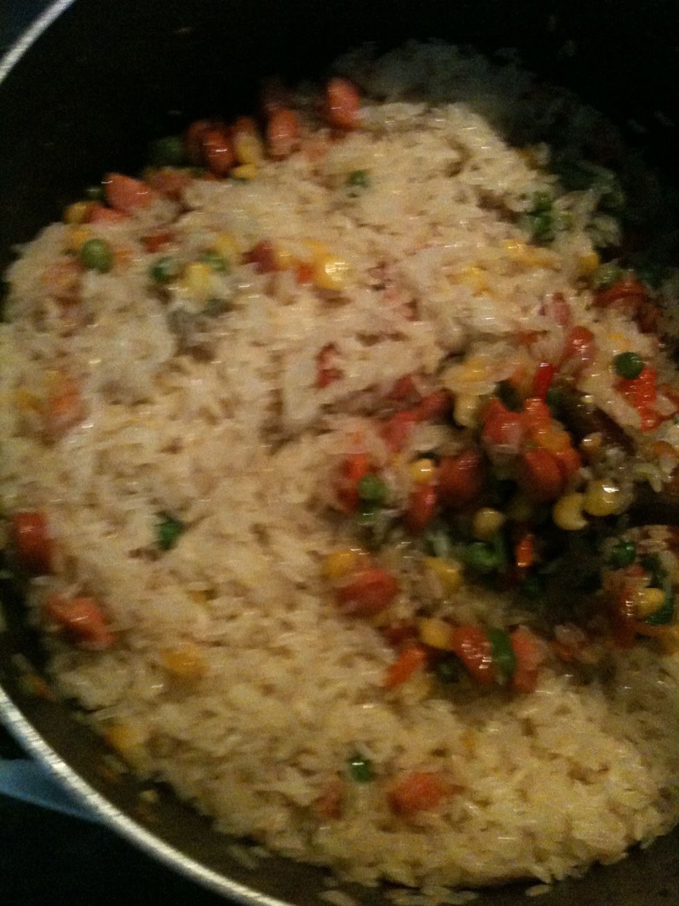 Pour the rice in n continue stir fryn until all d water from the rice is disappeared and you r actually fryn d rice