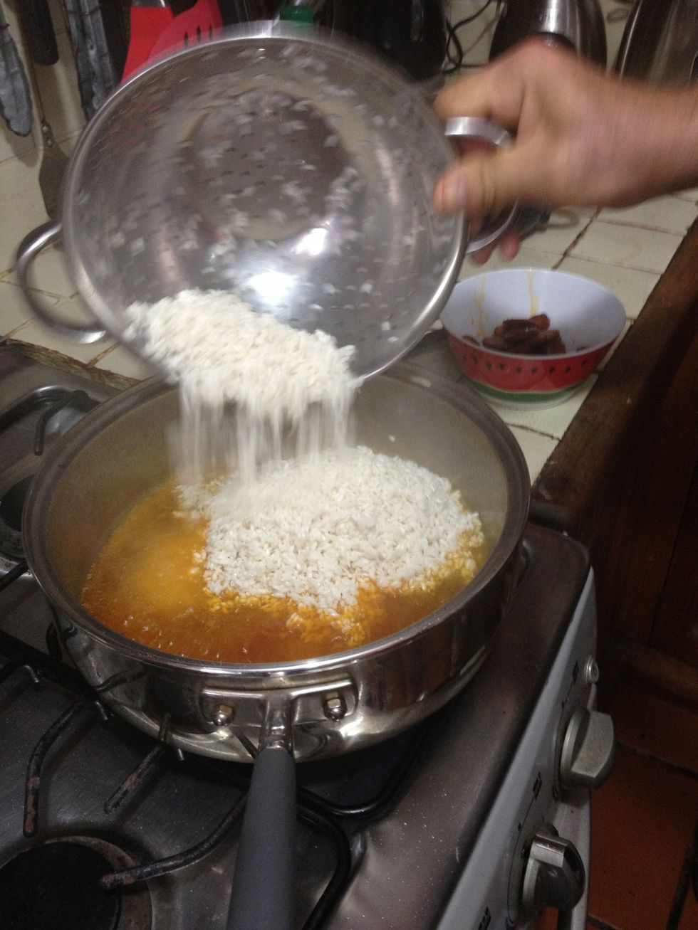 Pour the rice onto the chorizo oil.