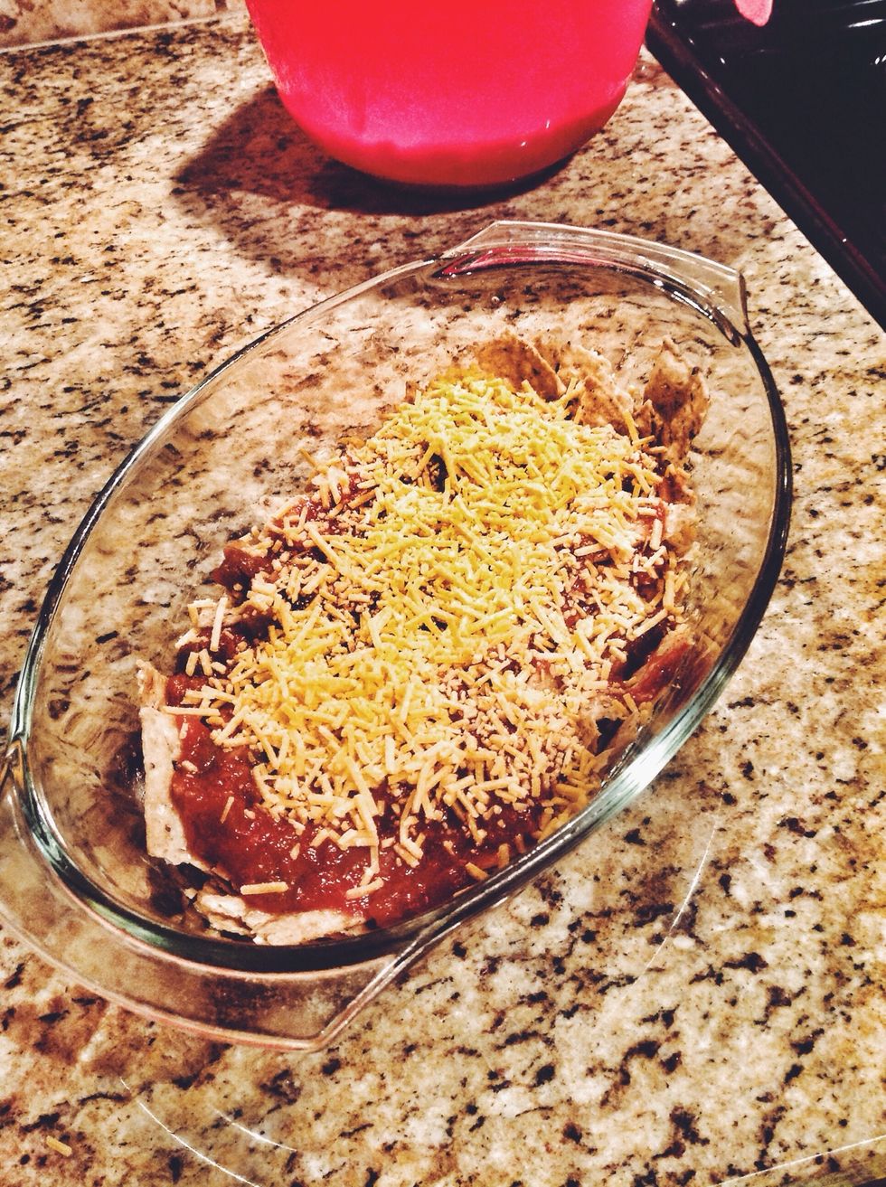 Pour the salsa over the chips. Do not smother the chips, simply add a generous layer. Sprinkle a generous layer of shredded cheese over the salsa. Lay the chicken breast atop the cheese.