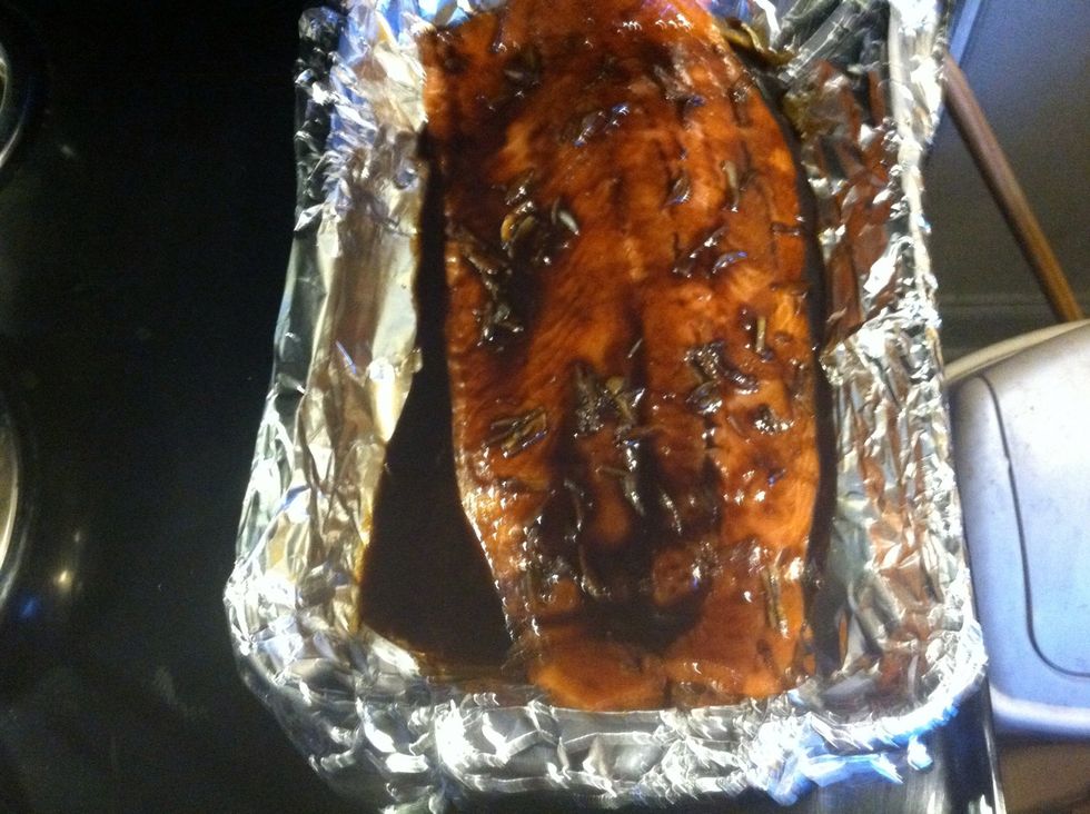 Pour the sauce on it, heat up your oven to 400 degrees . Do not cover the salmon leave it in the oven , for 13/14 minutes until it's flaking.