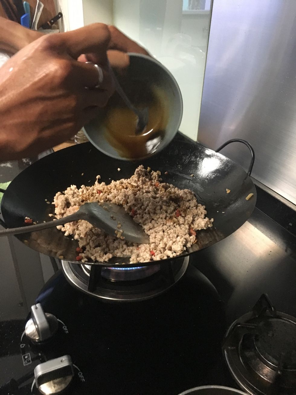 Pour the sauce that you make earlier on when your minced pork is fried up. Then continue stir frying it with the sauce in it. Do some tasting on the pork to see if the taste is there.